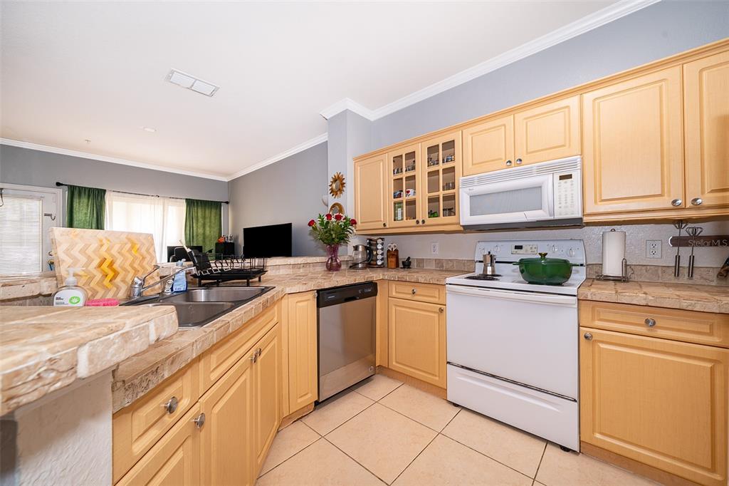 3707 Conroy Road, Unit 1715 Orlando, FL 32839 - Photo 10 of 20 a kitchen with stainless steel appliances granite countertop a stove sink and cabinets