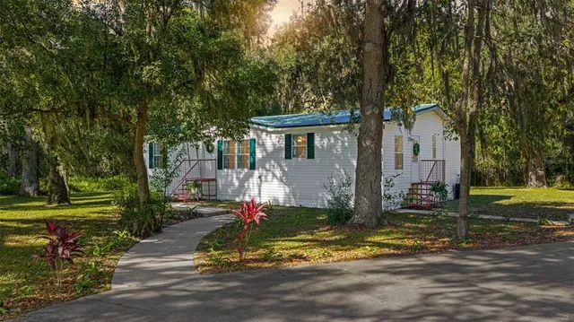 a view of a lake with a bench and trees around