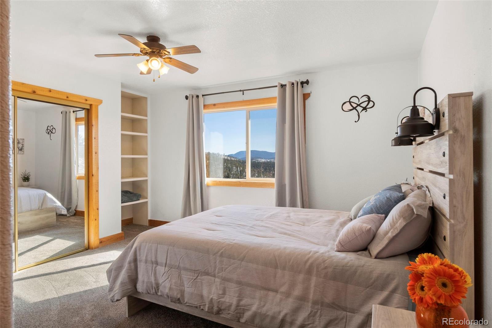 412 Evergreen Road Black Hawk, CO 80422 - Photo 32 of 48 a bedroom with a bed and a chandelier