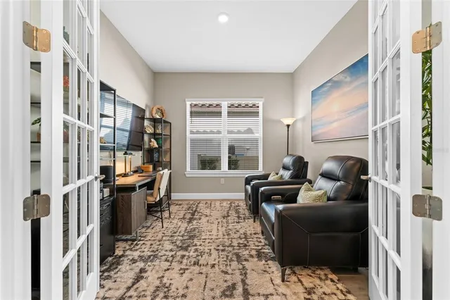 a living room with furniture and a floor to ceiling window