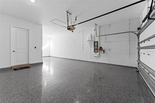 a living room with furniture kitchen view and a chandelier