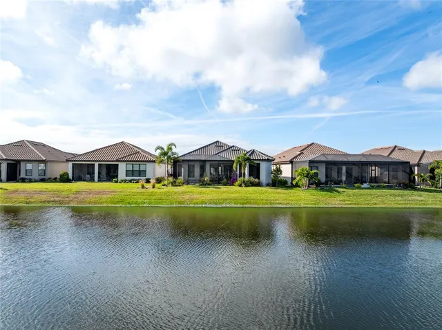 a front view of a house with a big yard and swimming pool