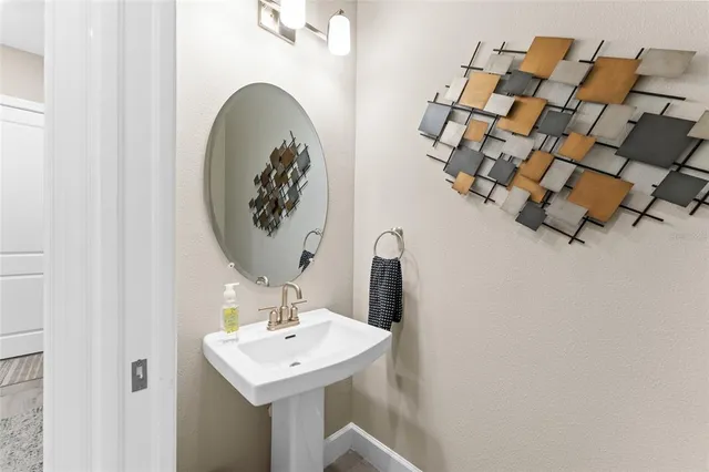 a living room with furniture a flat screen tv and a potted plant