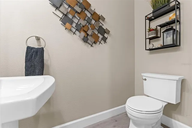 a view of a dining room and livingroom with furniture wooden floor a chandelier