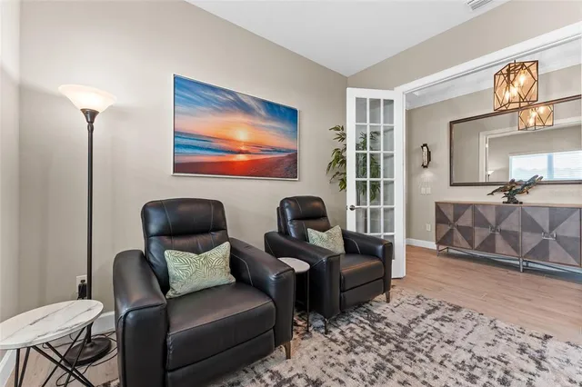 a large white kitchen with stainless steel appliances granite countertop lots of counter space and wooden floor