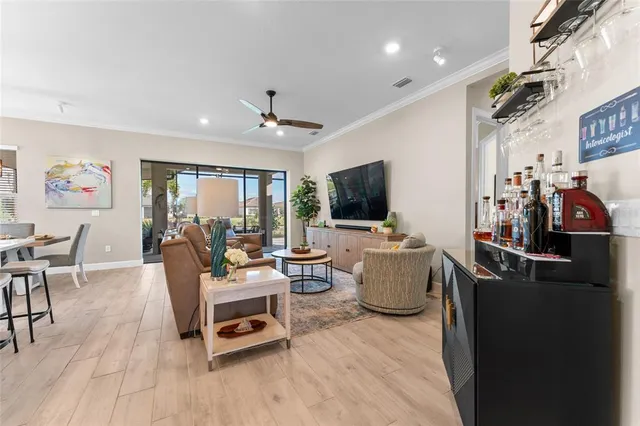 a kitchen with kitchen island granite countertop a table chairs microwave and cabinets