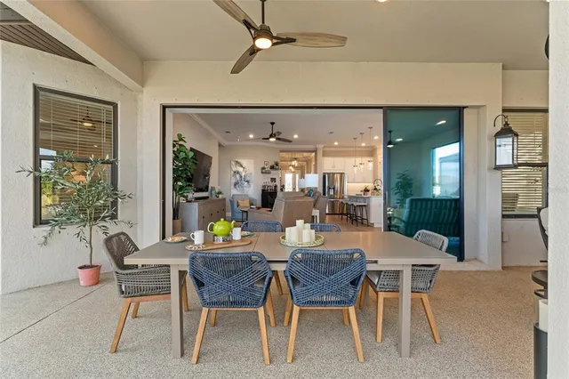 a kitchen with stainless steel appliances granite countertop a stove a sink a refrigerator and white cabinets with wooden floor