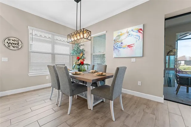 a view of a dining room with furniture wooden floor and a chandelier