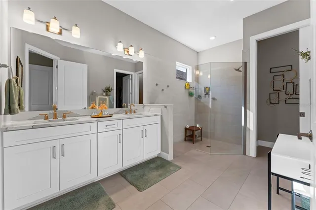 a spacious bathroom with a double vanity sink mirror and double