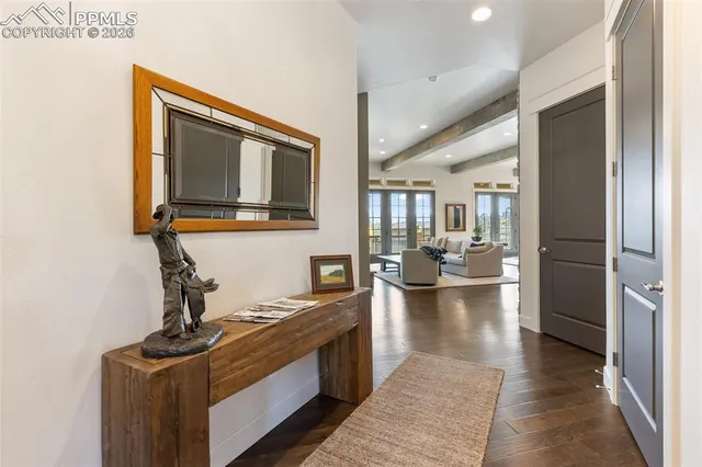a dining room with wooden floor and chandelier