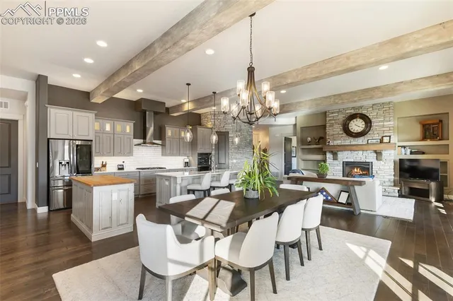 a living room with furniture a fireplace and a chandelier