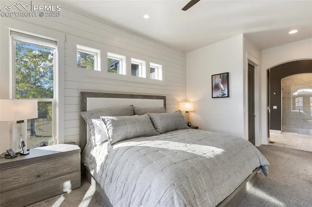 a bedroom with a bed and a mirror