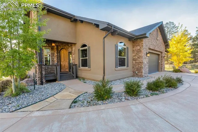 a front view of a house with white walls