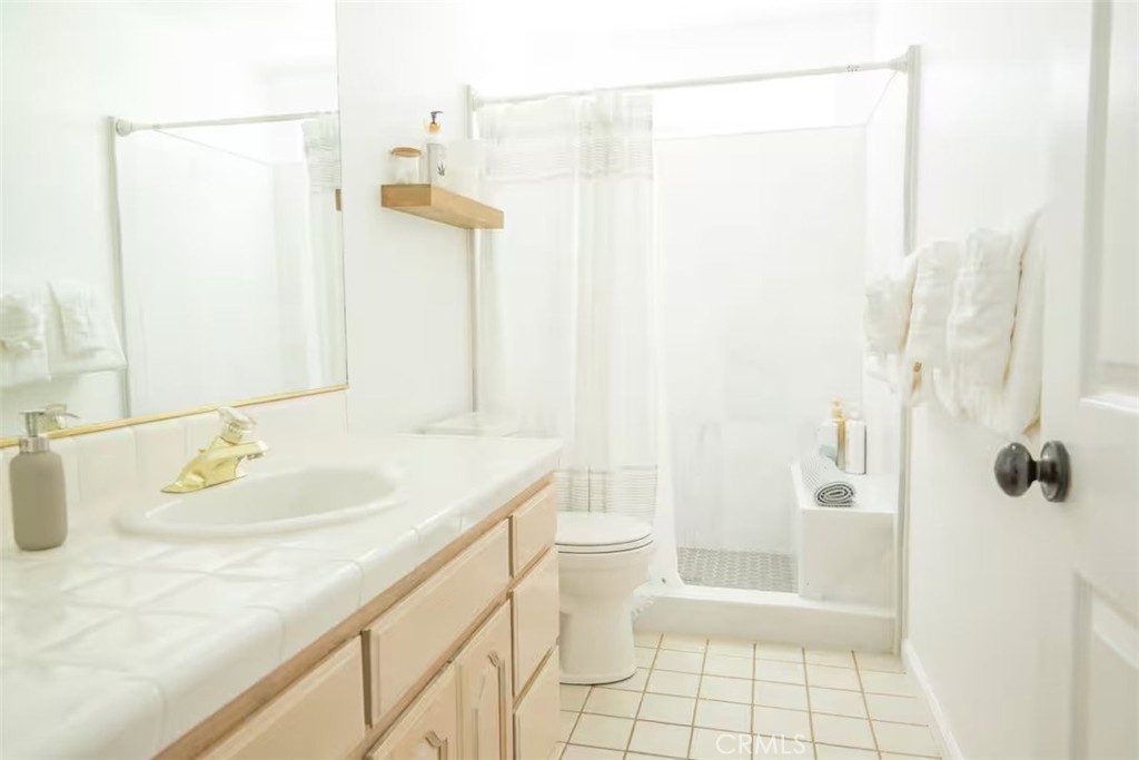 40584 Indian Springs Road Oakhurst, CA 93644 - Photo 13 of 21 a bathroom with a granite countertop sink a toilet and shower