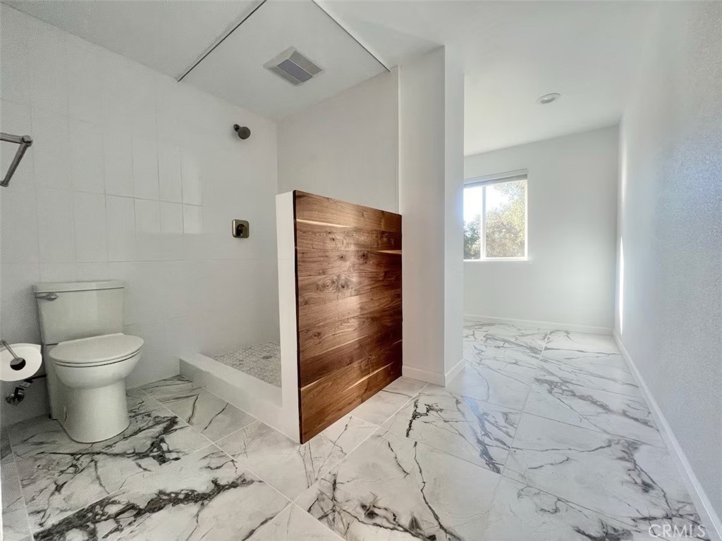 40584 Indian Springs Road Oakhurst, CA 93644 - Photo 14 of 21 a bathroom with a toilet sink and shower