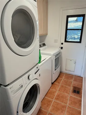 a utility room with sink dryer and washer