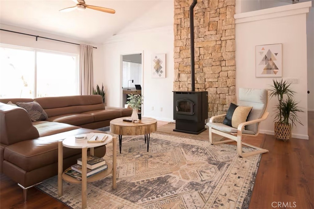 40584 Indian Springs Road Oakhurst, CA 93644 - Photo 2 of 21 a living room with furniture a fireplace and a table