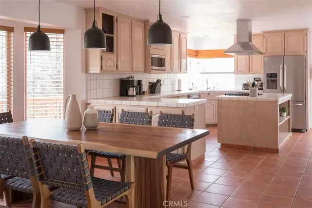 a kitchen with stainless steel appliances granite countertop a stove a sink a microwave and a refrigerator