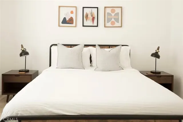 a bedroom with a bed and a chandelier