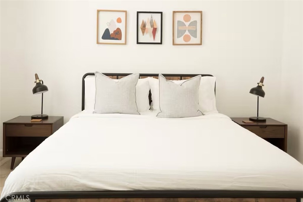 40584 Indian Springs Road Oakhurst, CA 93644 - Photo 8 of 21 a bedroom with a bed and a chandelier