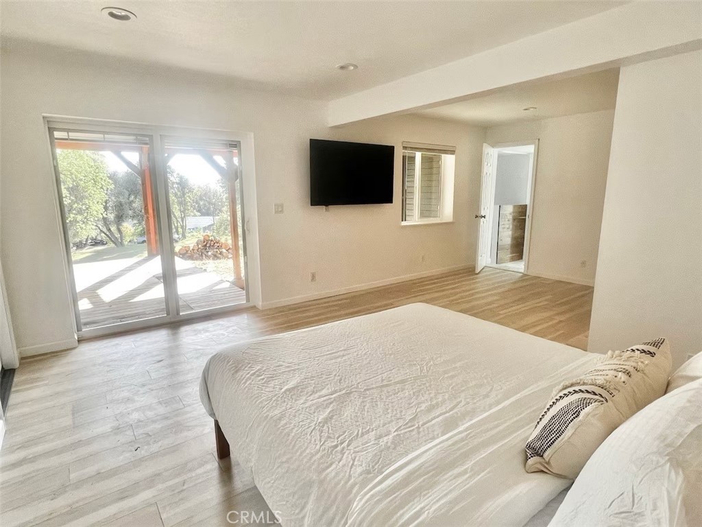 40584 Indian Springs Road Oakhurst, CA 93644 - Photo 10 of 21 a bedroom with a bed and a flat screen tv