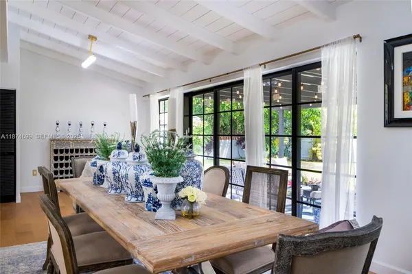 a dining room with furniture window and wooden floor