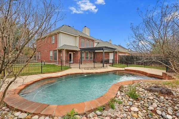 a view of a house with swimming pool and porch
