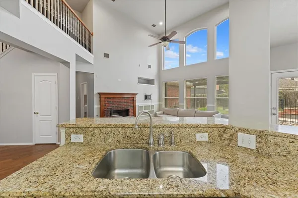 a kitchen with stainless steel appliances granite countertop a sink and a granite counter tops