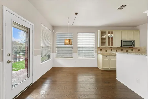 a view of kitchen with granite countertop a stove a sink and a granite counter top