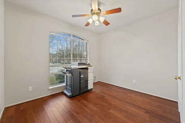 wooden floor in an empty room with a window