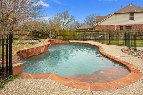 a view of a swimming pool with a patio