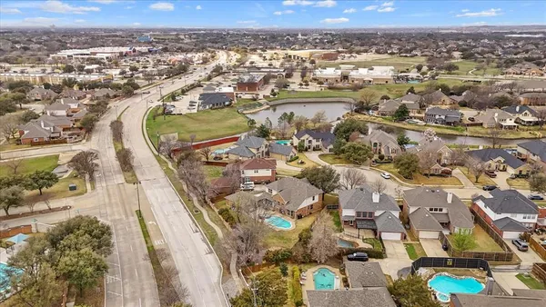an aerial view of residential houses with outdoor space