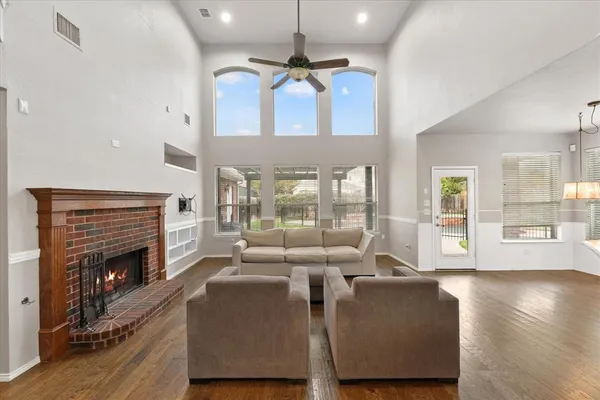 a living room with furniture large window and fireplace