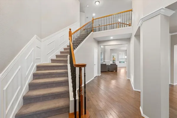a view of a hallway with wooden floor and entryway