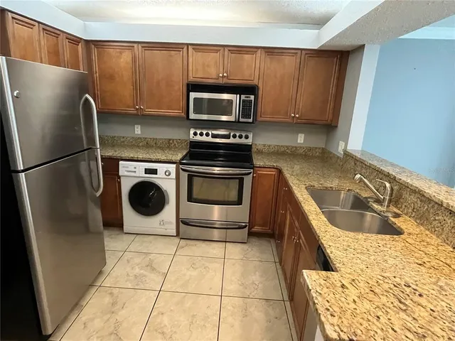 a view of a livingroom with an empty space and a window