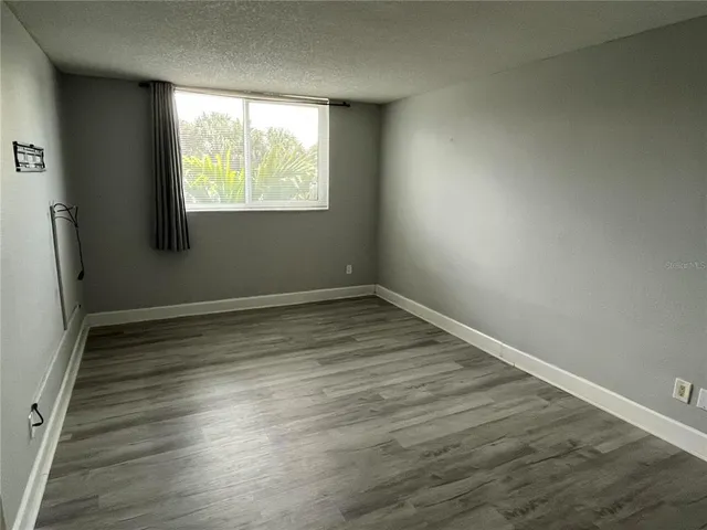 a bathroom with a granite countertop sink toilet mirror and shower