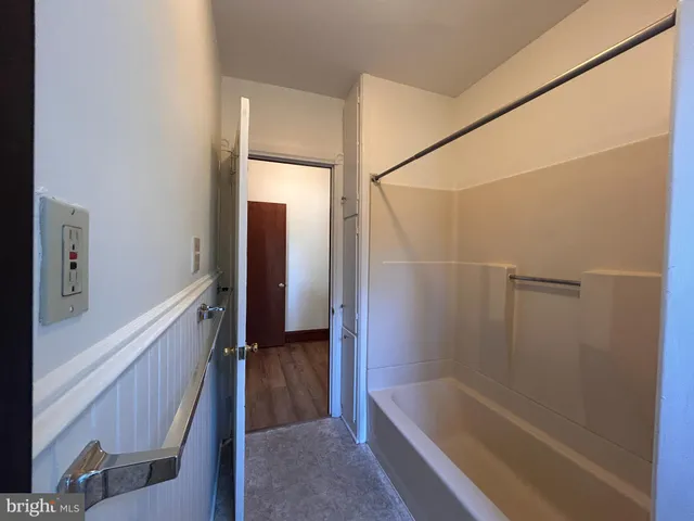 a bathroom with a bathtub and a shower