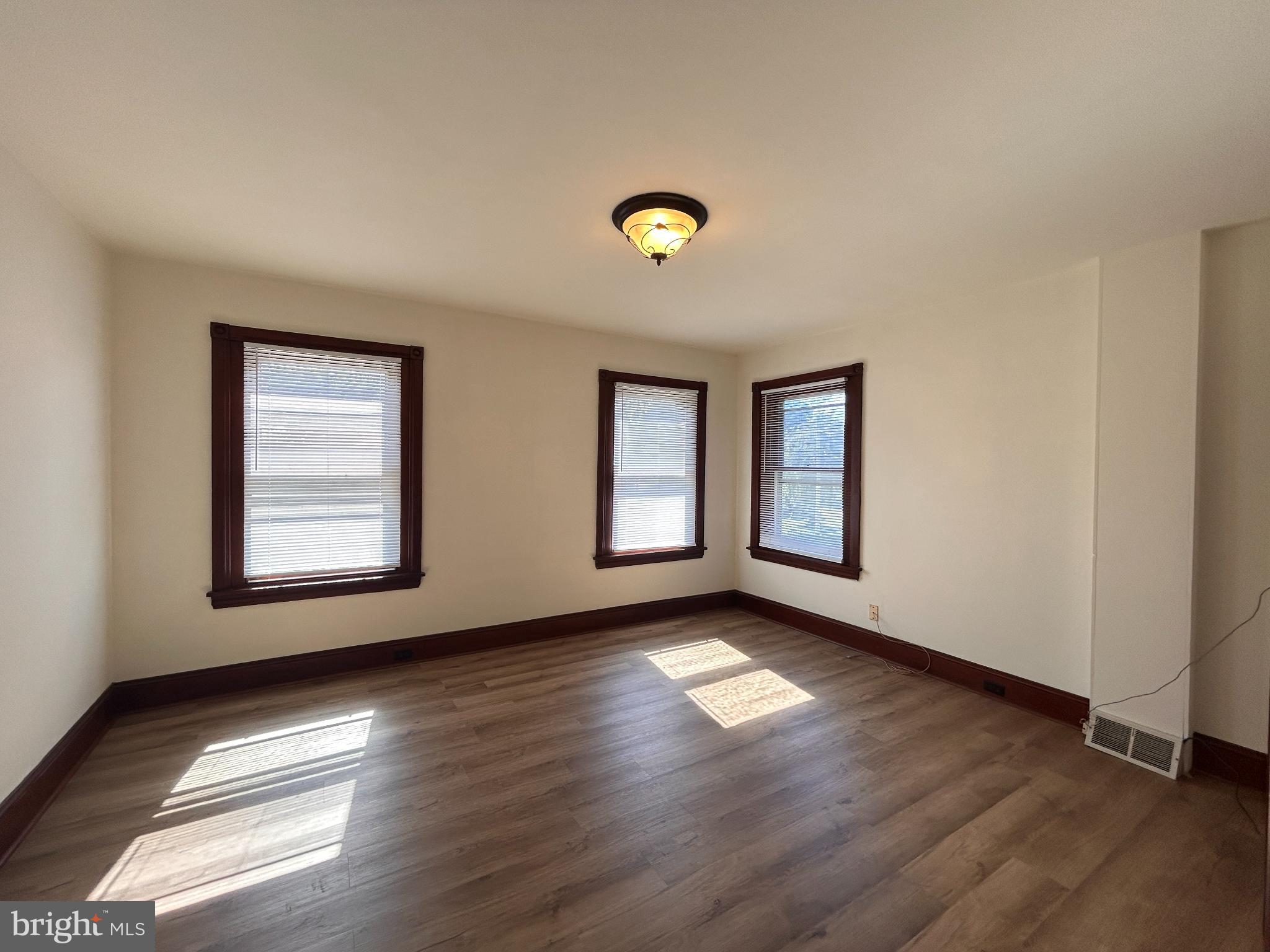 113 Dean Street, Unit 2 West Chester, PA 19382 - Photo 14 of 28 a view of an empty room with glass door and wooden floor