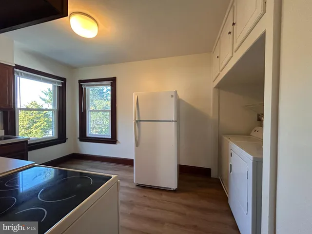 a kitchen with a refrigerator and a sink
