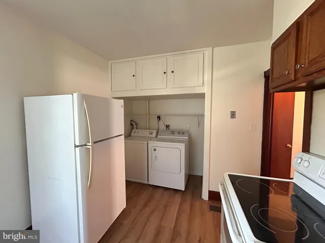 a kitchen with a refrigerator sink and cabinets