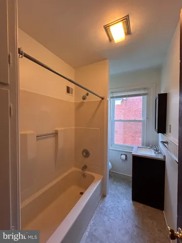 a bathroom with a bathtub a sink a vanity and a shower