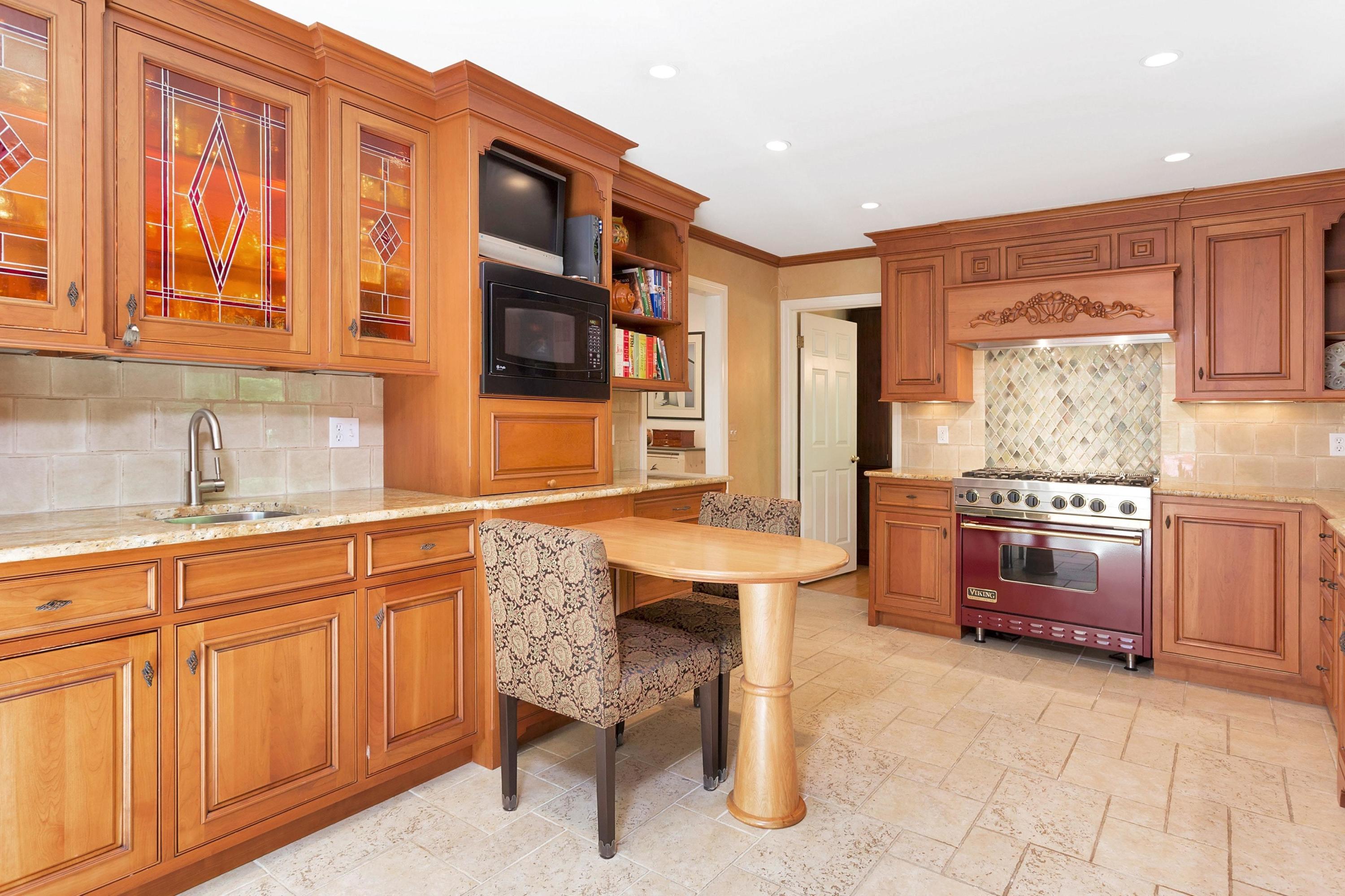 123 Tokeneke Road Darien, CT 06820 - Photo 7 of 23 a kitchen with granite countertop a sink stove and cabinets
