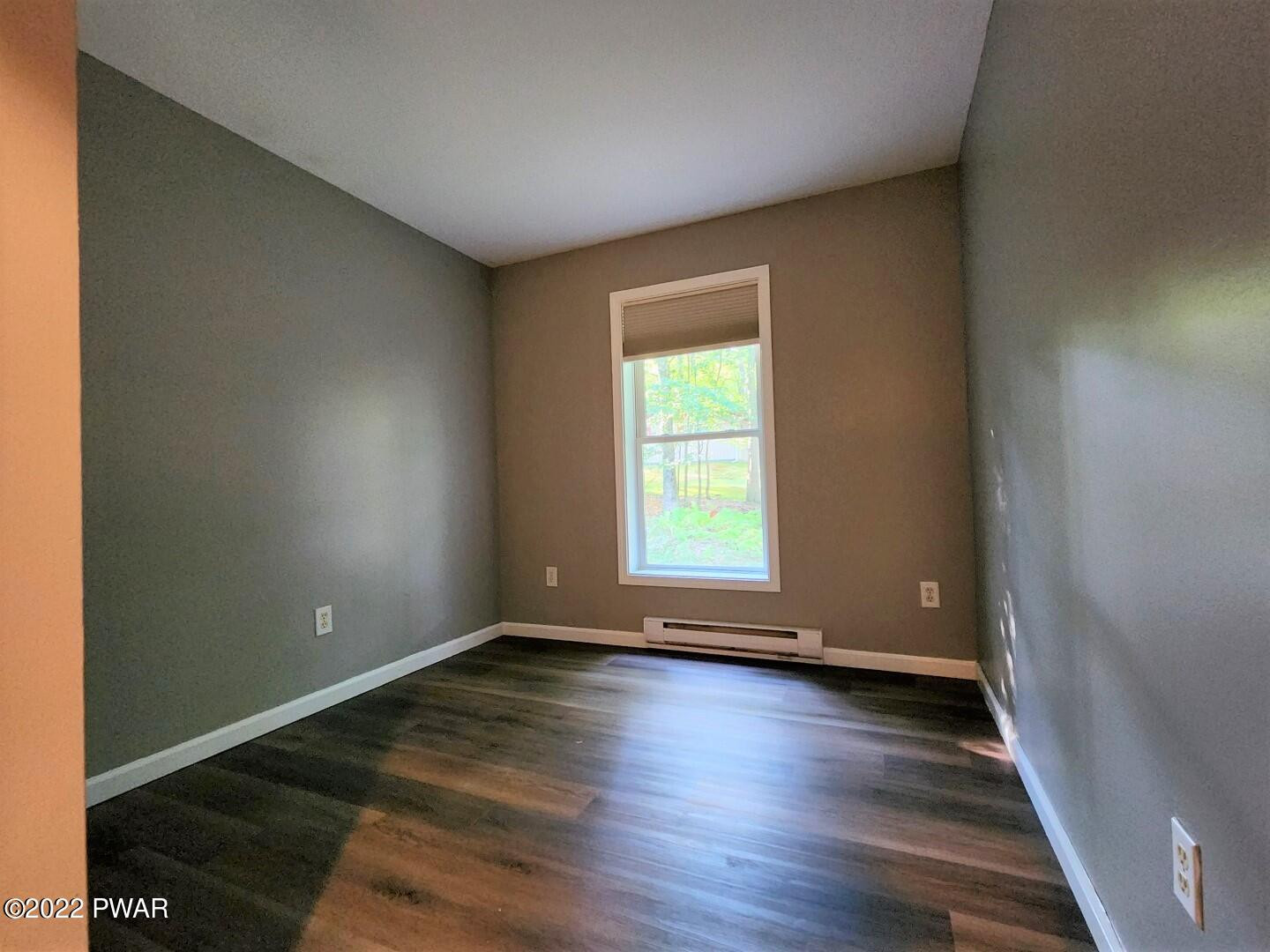 113 Butternut Road Milford, PA 18337 - Photo 8 of 15 an empty room with wooden floor and windows