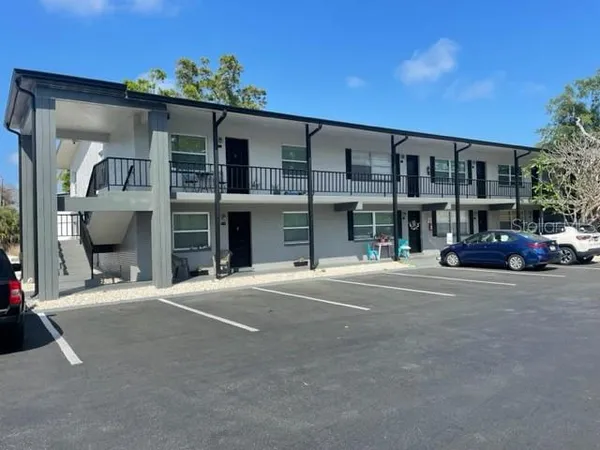 a couple of cars parked in front of a building