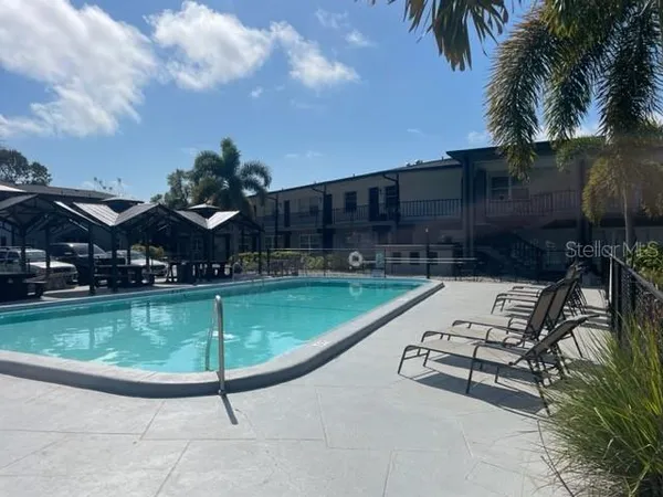 a swimming pool with outdoor seating and yard