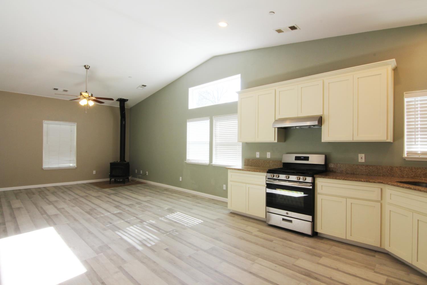 4968 Yaqui Gulch Road Mariposa, CA 95338 - Photo 12 of 28 a kitchen with granite countertop a stove a sink and a refrigerator