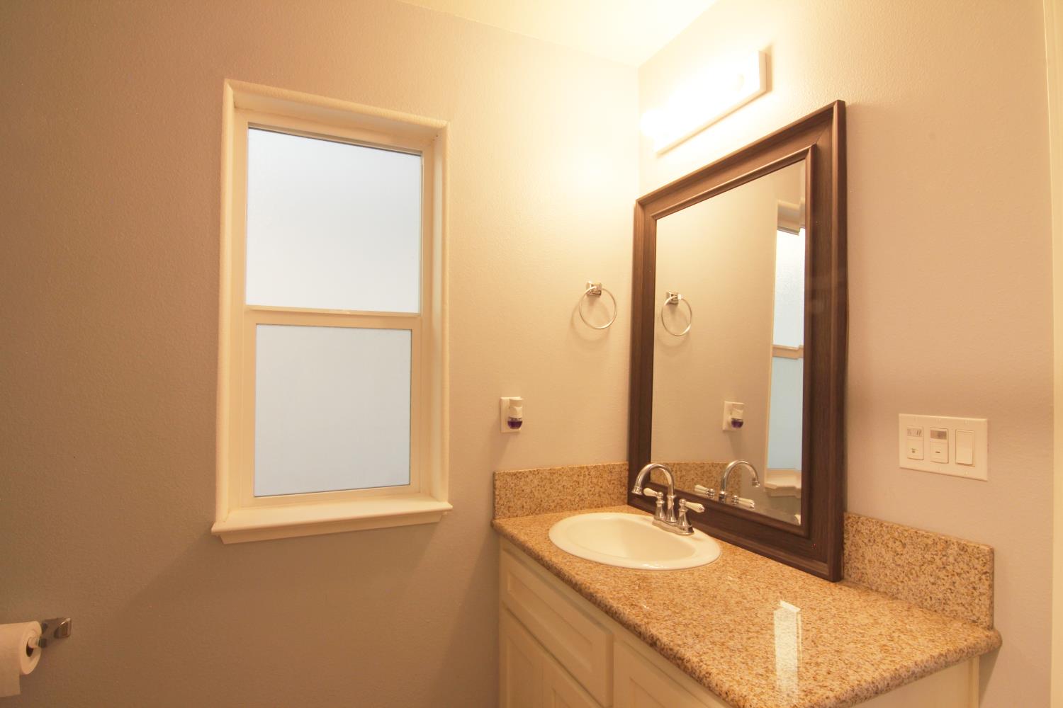 4968 Yaqui Gulch Road Mariposa, CA 95338 - Photo 17 of 28 a bathroom with a granite countertop sink and a mirror