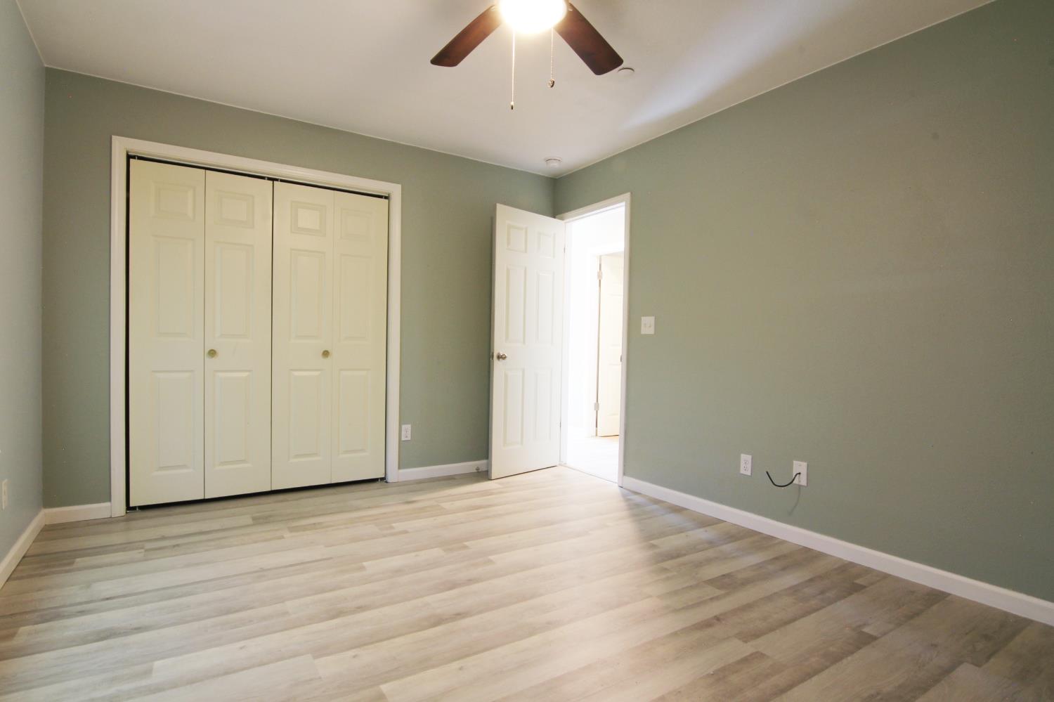 4968 Yaqui Gulch Road Mariposa, CA 95338 - Photo 18 of 28 an empty room with wooden floor and windows