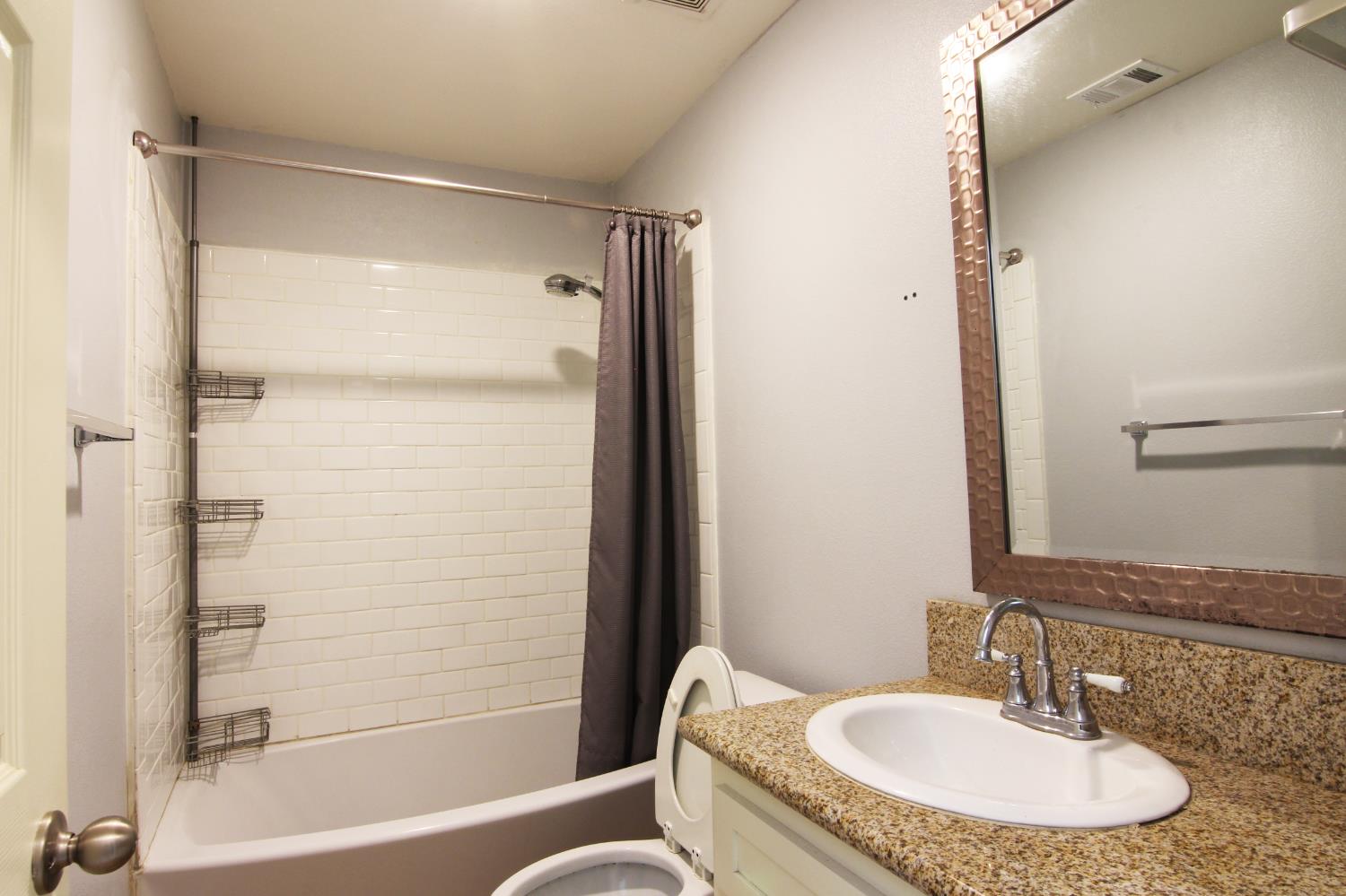 4968 Yaqui Gulch Road Mariposa, CA 95338 - Photo 20 of 28 a bathroom with a granite countertop sink and a mirror