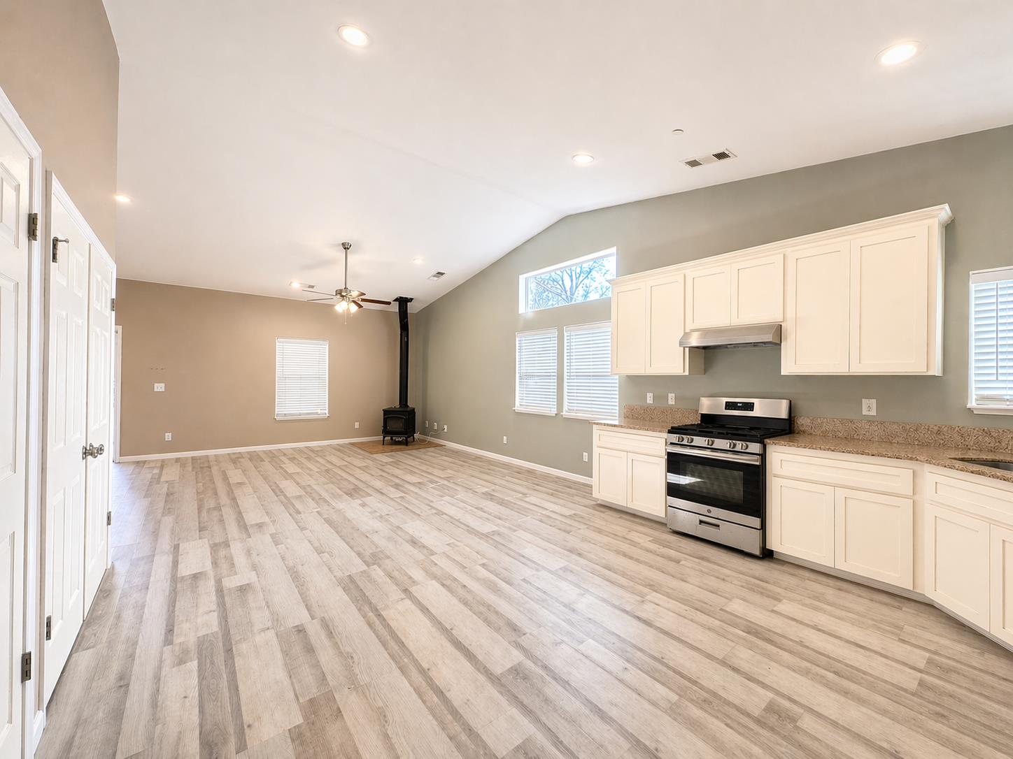 4968 Yaqui Gulch Road Mariposa, CA 95338 - Photo 7 of 35 a large kitchen with stainless steel appliances granite countertop a stove and a sink with cabinets